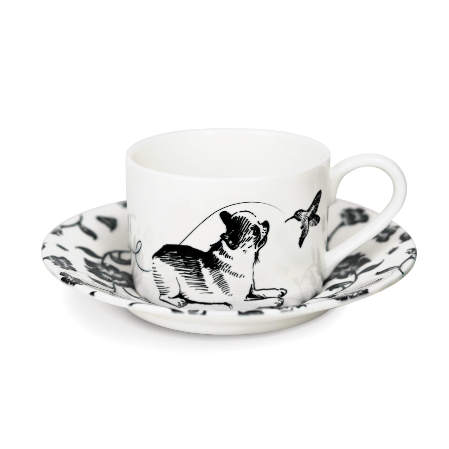 A black and white cup and saucer featuring a chihuahua design, elegantly displayed against a neutral background.